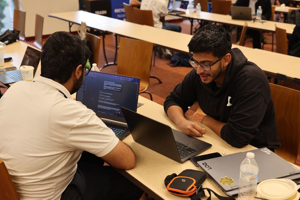 Two GaGro builders prototyping together on a laptop during a working session