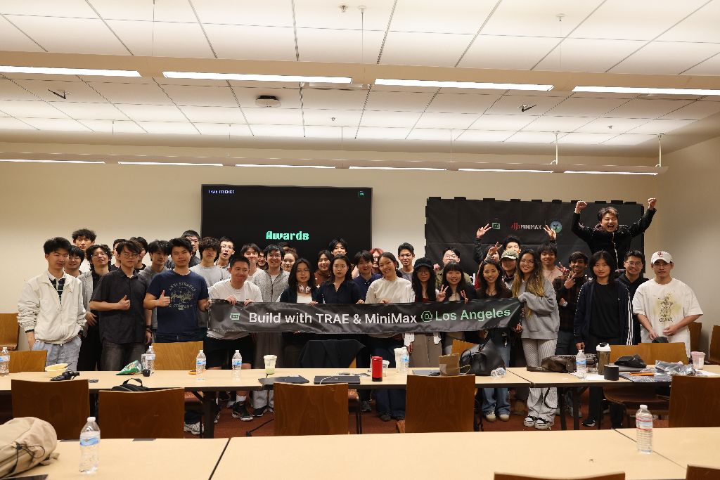 Founders celebrating on stage behind a Build with TRAE & MiniMax Los Angeles awards banner